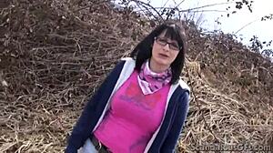 Amateur teen with perky tits and glasses gives a blowjob outdoors